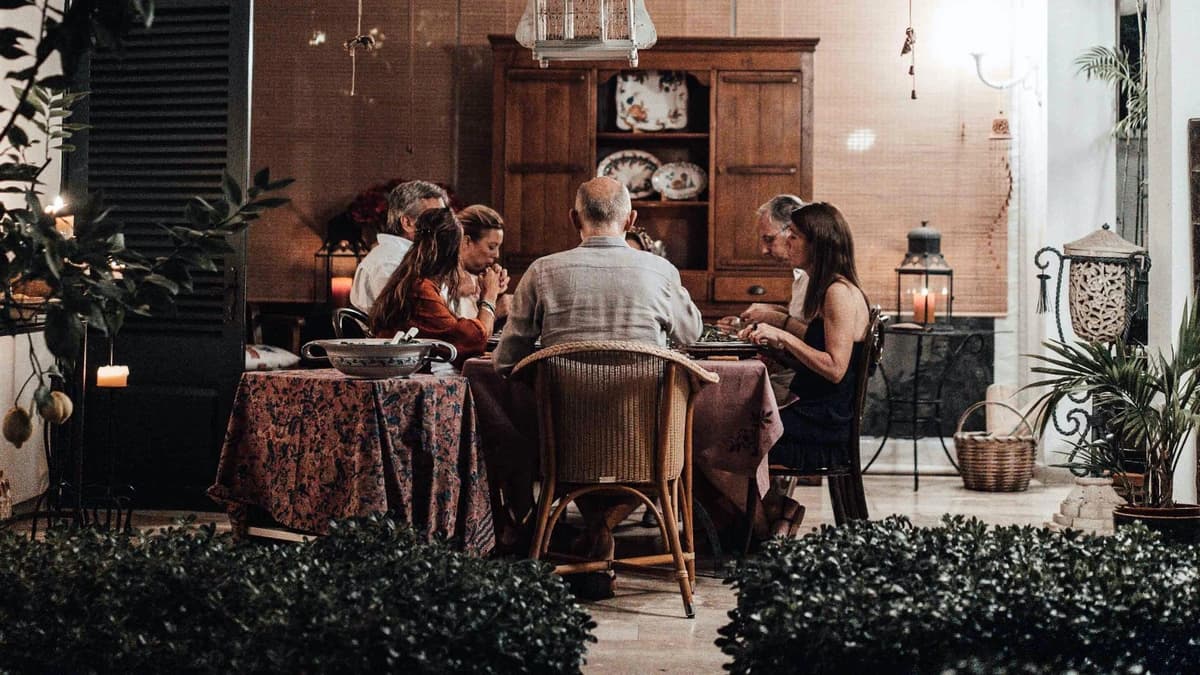 family sitting down holding hands