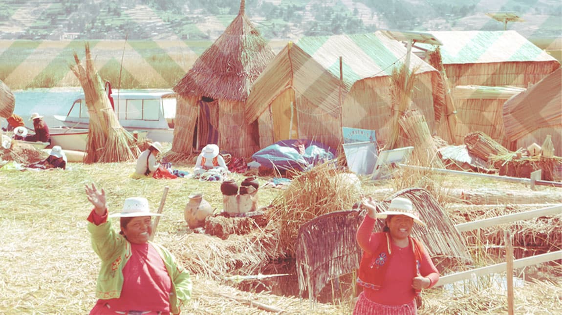 people in a village waving at the camera