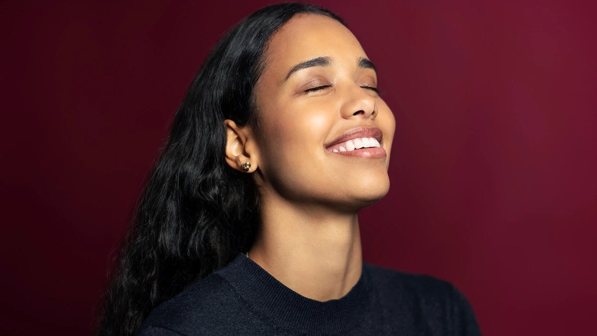 portrait of woman smiling with her eyes closed